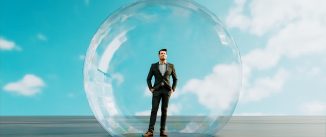 Digitally generated concept image of man inside a big bubble. It could be isolation for health reasons, but it could also be, that the man is inside a financial bubble.